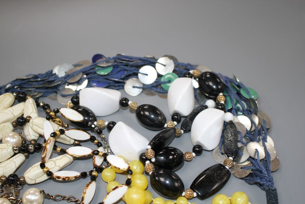 Six assorted costume necklaces including simulated amber and a costume bracelet,